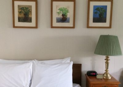 hotel room nightstand and paintings above